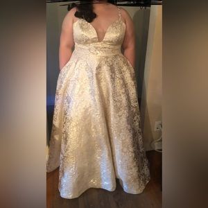 Beautiful Metallic Ballgown with white flowers, with pockets on the side.